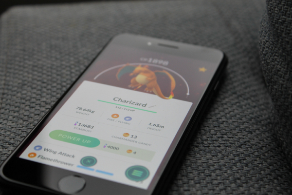 A smartphone showing a Charizard in the Pokemon Go game